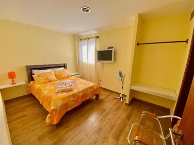 a bedroom with a bed and a television in it at Pensão Twins Carioca in Tarrafal