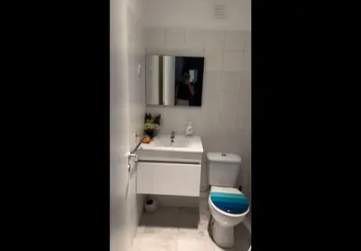 a bathroom with a white sink and a toilet at Micaya in Praia