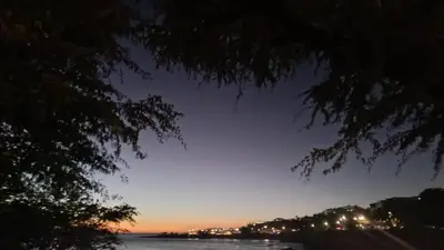 a view of the water at night at Diva Apartamento in Praia