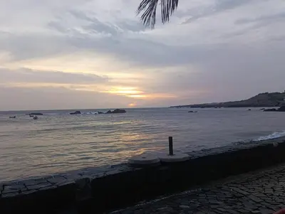 a view of the ocean with the sun setting at Diva Apartamento in Praia