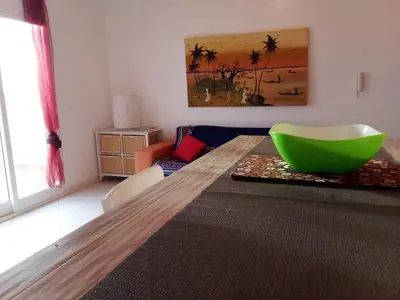 a living room with a table with a green bowl on it at Holiday Properties Vista Do Mar - Wi-fi in Santa Maria