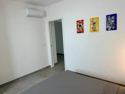 a white room with three paintings on the wall at Praça Presidente - By Bobbywashere in Santa Maria