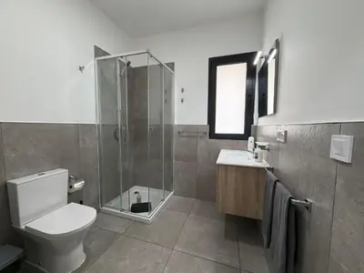 a bathroom with a shower and a toilet and a sink at Praça Presidente - By Bobbywashere in Santa Maria