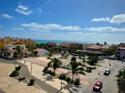 an aerial view of a town with houses and palm trees at Praça Presidente - By Bobbywashere in Santa Maria
