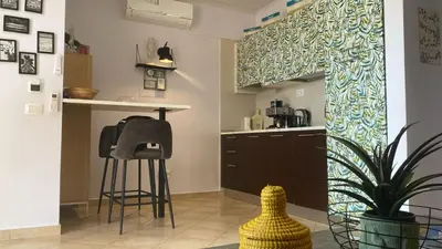 a kitchen with a counter and stools in a room at Tropical Palma in Santa Maria