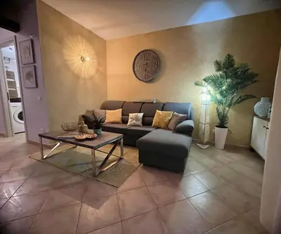 a living room with a couch and a table at Tropical Palma in Santa Maria