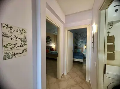 a hallway leading to a bedroom with a bed at Tropical Palma in Santa Maria