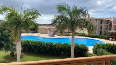 a swimming pool with two palm trees in a yard at Tropical Palma in Santa Maria