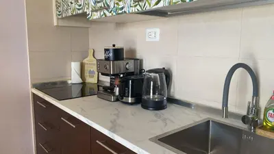 a kitchen with a coffee maker on a counter at Tropical Palma in Santa Maria