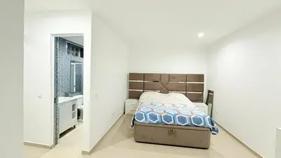 a bedroom with a bed and a sink in a room at Morabeza Home in Praia
