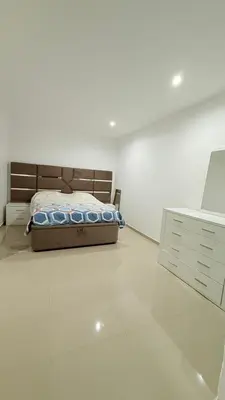 a bedroom with a bed in a white room at Morabeza Home in Praia