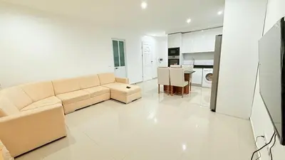 a white living room with a couch and a table at Morabeza Home in Praia