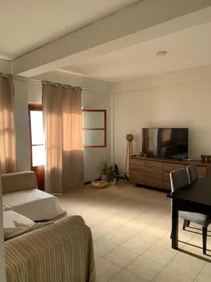 a bedroom with a bed and a flat screen tv at Shay's House in Mindelo in Mindelo