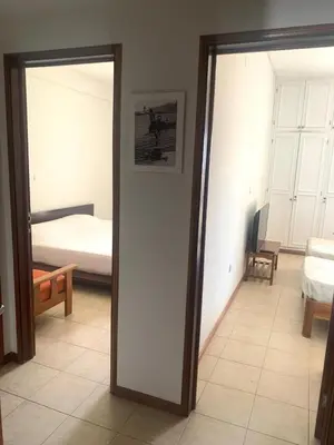 a room with a bedroom with a bed and a mirror at Shay's House in Mindelo in Mindelo