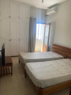 a bedroom with two beds and a window at Shay's House in Mindelo in Mindelo