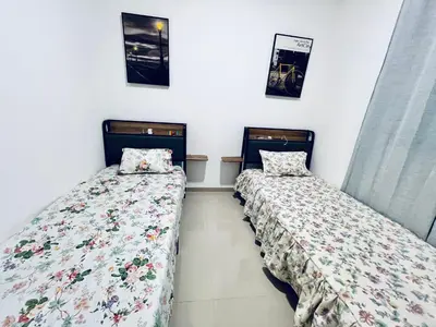 two beds sitting next to each other in a room at Shared Room with Balcony in Praia 5 Minute Walk to Beach in Praia