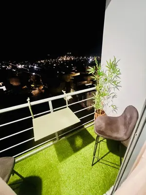 a balcony with a chair and a view of the city at Shared Room with Balcony in Praia 5 Minute Walk to Beach in Praia