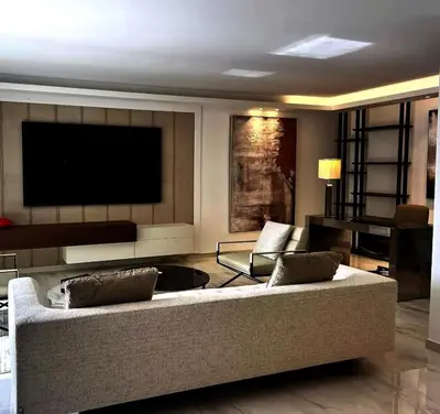 a living room with a couch and a flat screen tv at Sunshine Gold Spot in Santa Maria