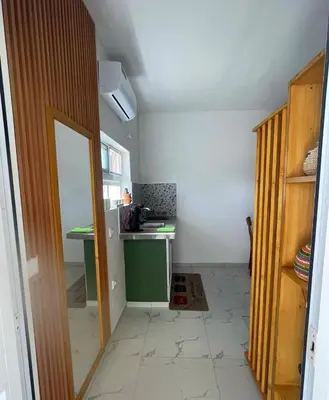 a room with a kitchen with a counter and a door at Studio Sol e Sal in Santa Maria