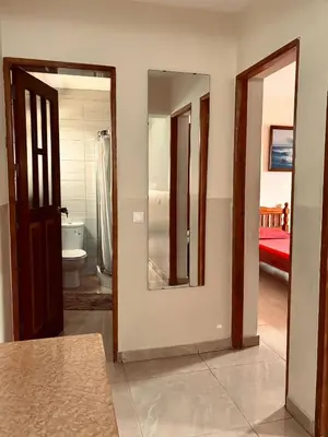 a room with a mirror and a bathroom with a toilet at Ferreira e Brito apartamentos in Espargos
