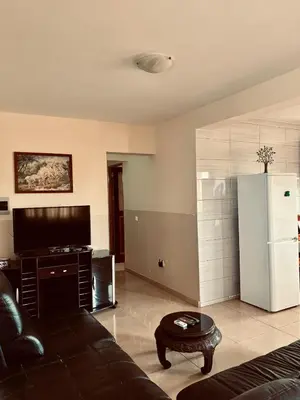a living room with a couch and a refrigerator at Ferreira e Brito apartamentos in Espargos