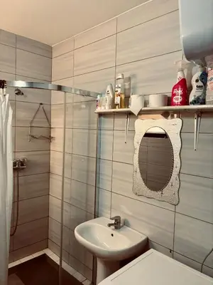 a bathroom with a sink and a toilet and a shower at Ferreira e Brito apartamentos in Espargos