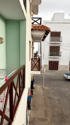 a building with awning next to a street at Verdes Anos - local accommodation in Santa Maria in Santa Maria