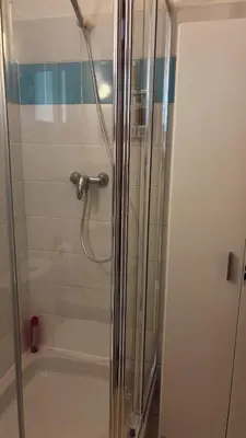 a shower with a glass door in a bathroom at Verdes Anos - local accommodation in Santa Maria in Santa Maria