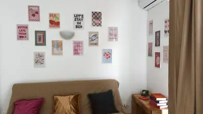 a living room with a couch and pictures on the wall at Verdes Anos - local accommodation in Santa Maria in Santa Maria