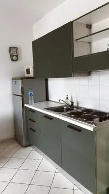 a kitchen with green cabinets and a sink at Verdes Anos - local accommodation in Santa Maria in Santa Maria