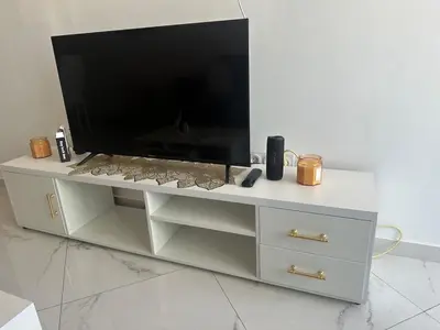 a white entertainment center with a large television on it at Bestview of Palmarejo in Praia