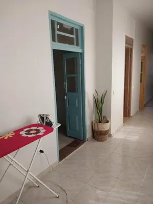 a room with a red table and a blue door at Sol, Terra e Mar- No coração do Plateau in Praia