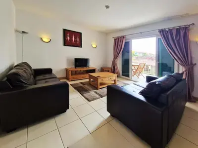 a living room with two couches and a television at 1 bedroom apartment in Vila Verde Resort in Santa Maria