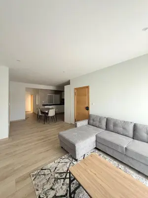 a living room with a couch and a table at Spacious apartment in Praia Great for families in Montagarro