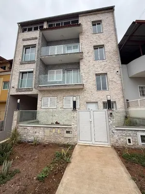 a building with two white doors in front of it at Spacious apartment in Praia Great for families in Montagarro
