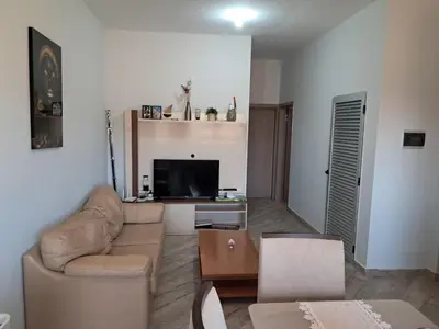 a living room with a couch and a tv at T1 Cá Djana in Sal Rei