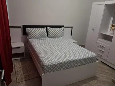a bedroom with a bed with a black and white comforter at T1 Cá Djana in Sal Rei