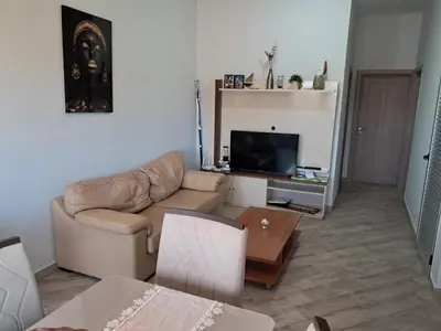 a living room with a couch and a television at T1 Cá Djana in Sal Rei