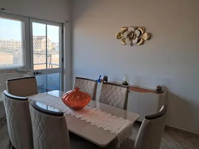 a dining room table with a vase on top of it at T1 Cá Djana in Sal Rei