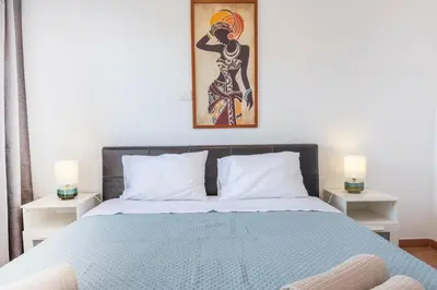a bedroom with a bed with a blue comforter at Casa do Sal - AC, Free Wi-Fi, Near Beach in Santa Maria