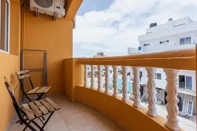 a balcony with a wooden railing and a chair at Casa do Sal - AC, Free Wi-Fi, Near Beach in Santa Maria