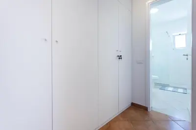a bathroom with white walls and a glass door at Casa do Sal - AC, Free Wi-Fi, Near Beach in Santa Maria