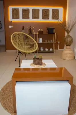 a table and a chair in a room at T2 City Center in Mindelo