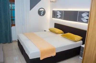 a bedroom with a bed with two yellow pillows at T2 City Center in Mindelo