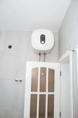 a bathroom with a shower with a phone on the wall at Morabeza T2 City Center in Mindelo