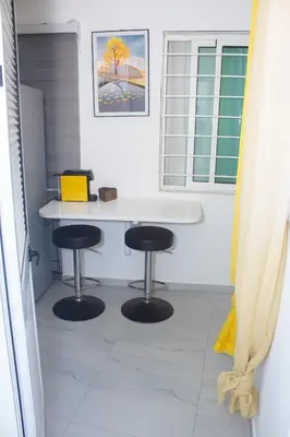 an office with a white desk and two stools at Morabeza T2 City Center in Mindelo
