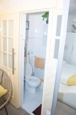 a bathroom with a toilet and a tub at Studio Morna City Center in Mindelo
