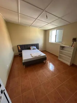 a bedroom with a bed and a tiled floor at Home Lenda in Tarrafal