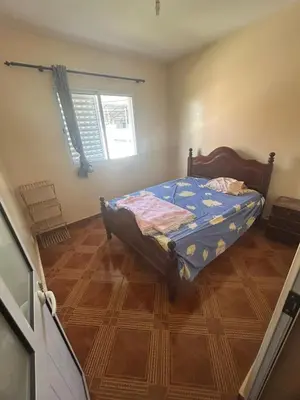 a bedroom with a bed in the corner of a room at Home Lenda in Tarrafal