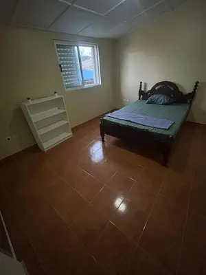 a bedroom with a bed and a tiled floor at Home Lenda in Tarrafal